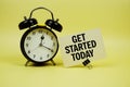 Get Started Today text message on paper card with alarm clock on yellow background