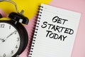 Get Started Today text written on notepad with alarm clock on pink background Royalty Free Stock Photo