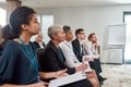 Get Together. Multi-ethnic audience sitting in a row while listening to presentation at conference hall Royalty Free Stock Photo