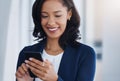 Get in touch with those who will help you succeed. a young businesswoman using a cellphone in an office. Royalty Free Stock Photo