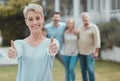 They get two thumbs up. a mature woman showing a thumbs up in the garden at home. Royalty Free Stock Photo