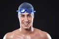 Get up, get motivated. Studio portrait of a young male swimmer with goggles and cap. Royalty Free Stock Photo