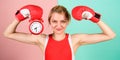 Get used to personal regime. Girl athlete boxing gloves and alarm clock. Sport lifestyle and healthy regime. Habits and