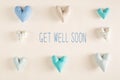 Get well soon message with blue heart cushions Royalty Free Stock Photo
