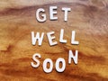 Get Well Soon Message on Wooden Table Royalty Free Stock Photo