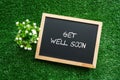 GET WELL SOON text in white chalk handwriting on a blackboard Royalty Free Stock Photo