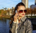 Young trendy woman speaking on cell phone near Eiffel tower Royalty Free Stock Photo