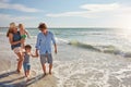 Get your feet wet. a young family enjoying a summer day out at the beach. Royalty Free Stock Photo