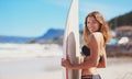 Get your surf on. Portrait of a young surfer standing on the beach. Royalty Free Stock Photo