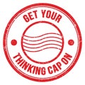 GET YOUR THINKING CAP ON text on red round postal stamp sign Royalty Free Stock Photo