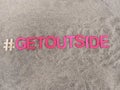 #getoutside get outside written on sand at the beach Royalty Free Stock Photo