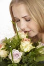 She gets a bouquet of flowers (roses) fpr birthday Royalty Free Stock Photo