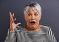 She gets scared very easily. Portrait of a mature woman with a frightened look on her face. Royalty Free Stock Photo