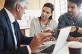 Getting all the facts before they make a decision. a young married couple consulting with their financial advisor in his Royalty Free Stock Photo