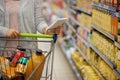 Getting all the groceries she needs. Closeup shot of a woman checking her shopping list in a grocery store. Royalty Free Stock Photo