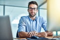 Getting business done. Portrait of a young businessman sitting at an office desk. Royalty Free Stock Photo