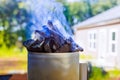 Getting charcoal ready for grill is as easy as using a BBQ chimney starter Royalty Free Stock Photo