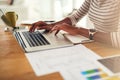 Getting closer to achieving success. an unrecognizable woman working on her laptop at home. Royalty Free Stock Photo