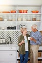 Getting cozy in the kitchen with coffee. a happy senior couple bonding over coffee in their kitchen at home. Royalty Free Stock Photo