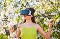 Getting 3D imagery. Innovative vr technology. Pretty girl in virtual reality headset. Cute girl play in spring garden Royalty Free Stock Photo