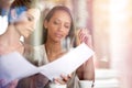 Getting down to business with coffee. Two women discussing paperwork during a business meeting at a cafe. Royalty Free Stock Photo