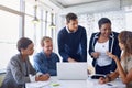 Getting down to business. a team of businesspeople working on a laptop together at a table in the office. Royalty Free Stock Photo