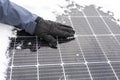Getting electricity with solar panels in winter.Hands clear snow from solar panels.renewable energy in winter time Royalty Free Stock Photo