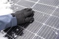 Getting electricity with solar panels in winter.Hands clear snow from solar panels.renewable energy in winter time.Solar Royalty Free Stock Photo