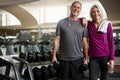 Getting fit together. a senior married couple smiling and taking a break from their workout at the gym. Royalty Free Stock Photo