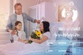 Smiling woman staying in a hospital bed and her relatives giving her flowers Royalty Free Stock Photo