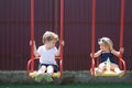 Getting a fresh haircut. Hair salon for children. Small brother and sister enjoy playing together. Girl and boy haircut