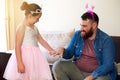 Getting a girly makeover just to see her smile. an adorable little girl painting her fathers nails at home. Royalty Free Stock Photo