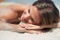 Getting golden. an attractive young woman lying on the beach in a bikini. Royalty Free Stock Photo