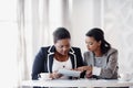 Getting her opinion. two attractive young businesswomen working together behind a desk in their office. Royalty Free Stock Photo