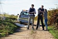 Getting her statement. Shot of a woman showing police officers where she found the body at a crimescene.