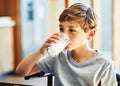 Getting his daily dose of calcium. Shot of a young boy drinking a glass of milk at home. Royalty Free Stock Photo