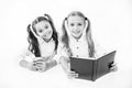 Getting information. Modern data storage instead big paper book. Little girls read paper book and ebook smartphone Royalty Free Stock Photo