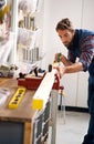 Getting those measurements just right. a handsome young carpenter measuring a piece of wood.