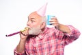 Getting older is still fun. Elderly people. Man bearded grandpa with birthday cap and drink cup. Birthday crazy party