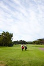 Getting out amongst nature. Rear view shot of two friends out on the golf course together.