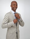 Getting ready for the big meeting. A young african american businessman doing his tie up while isolated on a white Royalty Free Stock Photo