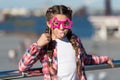 Getting ready for party. Small naughty girl having fun. Fashionable glasses for celebration. Stylish look. Disobedient Royalty Free Stock Photo