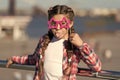 Getting ready for party. Small naughty girl having fun. Fashionable glasses for celebration. Stylish look. Disobedient Royalty Free Stock Photo