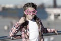 Getting ready for party. Small naughty girl having fun. Fashionable glasses for celebration. Stylish look. Disobedient Royalty Free Stock Photo