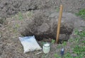 Getting ready to plant a tree in spring by digging a deep and wide hole, spare for the tree roots and preparing mineral