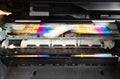 Colour printer ink cartridges in motion Close up. Royalty Free Stock Photo