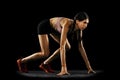 Ready to start. Studio shot of young muscular woman running isolated on black background. Sport, track-and-field Royalty Free Stock Photo