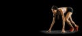 Ready to start. Studio shot of young muscular woman running isolated on black background. Sport, track-and-field Royalty Free Stock Photo