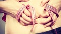 Woman touching stomach holding measuring tape Royalty Free Stock Photo