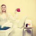 Happy woman showing cup of tea Royalty Free Stock Photo